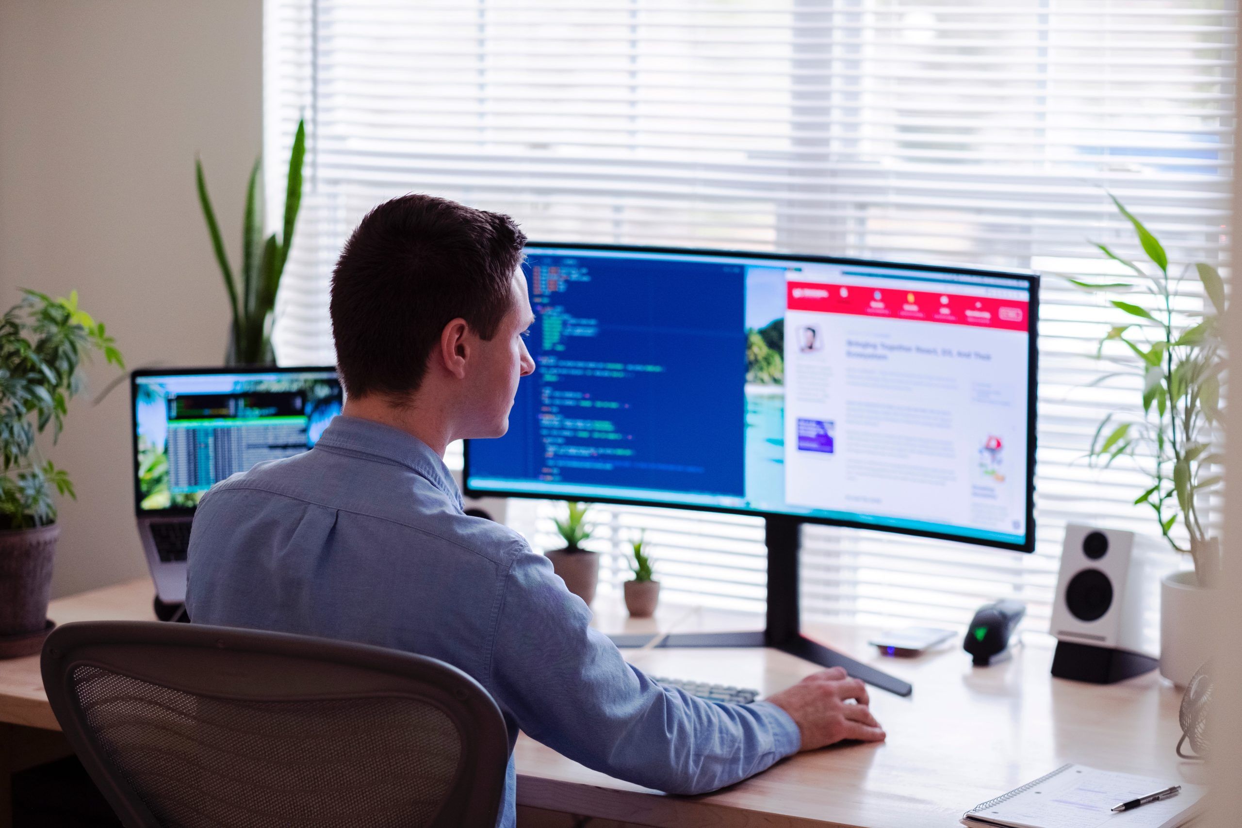 Man sitting at table in front of computer, Cybersecurity, Ransomware Protection