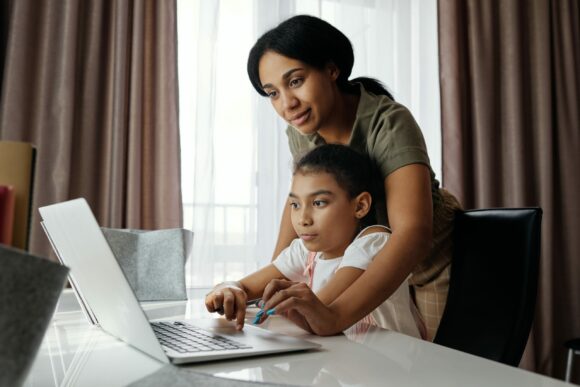 mother and child sitting at table on laptop, Cyberscore, cybersecurity companies Chicago