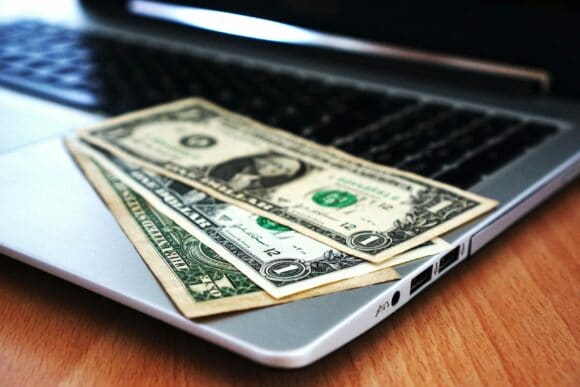 money on laptop - cybersecurity budget