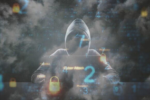 Person in hoodie in front of computer, LeadingIT, Cybersecurity